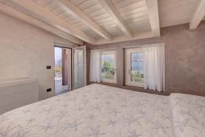 a large bedroom with a large bed with windows at Villa Orchidea in Onno +38 photos
