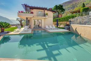 a villa with a swimming pool and a house at Villa Orchidea in Onno