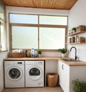a kitchen with a washing machine and a sink at b&b Il Siriaco in Calatabiano