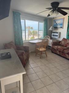 a living room with a couch and a table at Sierra Suites in Daytona Beach