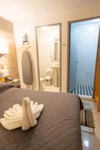 a bedroom with a bed with two towels on it at El Suburbio - Morelos Sur in Morelia +91 photos