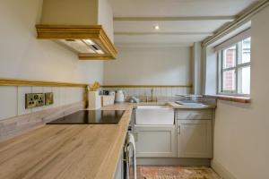 a kitchen with white cabinets and a counter top at 1 Bed in Holt oc-p34797 in Holt