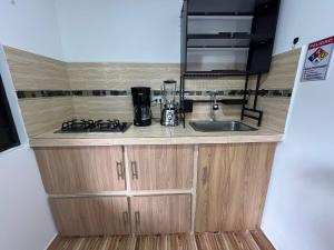 a kitchen counter with a sink and a stove at APARTAMENTO CONFORTABLe 200 in Arauca