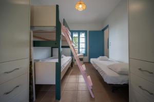 a bedroom with two bunk beds and a staircase at Xiro Retreat in Xiropigado