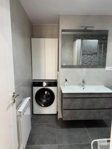 a kitchen with a washing machine and a sink at Cabalo Holiday Inn in Tui +24 photos