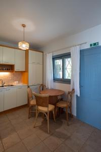 a kitchen with a table and chairs and a table and a kitchen at Xiro Retreat in Xiropigado +53 photos