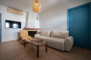 a living room with a couch and a fire place at Xiro Retreat in Xiropigado