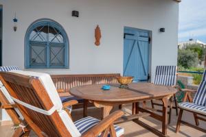 a wooden table and chairs on a patio at Xiro Retreat in Xiropigado