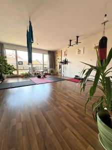 a living room with a hard wood floor at Sunny Gym Studio Apartment in Burgas +11 photos