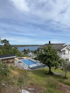 an aerial view of a house with a swimming pool at Beautiful pool villa with stunning ocean view in Tyresö