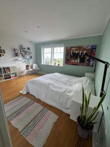 a bedroom with a white bed and a window at Beautiful pool villa with stunning ocean view in Tyresö +36 photos