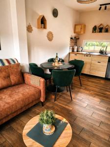 a living room with a couch and a table at Silvarium Kaszuby Domek Sosna in Stężyca