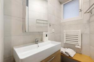 a white bathroom with a sink and a mirror at Chez Emilien in Bordeaux +31 photos