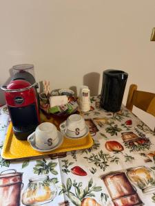 a table with a coffee maker and dishes on it at Affittacamere Castelmanardo in Amandola