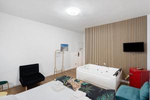 a living room with a bath tub and a chair at Mirosa Luxury Rooms in Pompei +48 photos