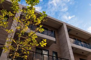 a building with a tree in front of it at Buluba in Yuanshan