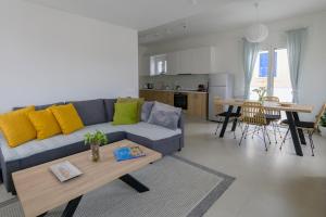 a living room with a couch and a table at Irma's Apartments in Pilos in Pylos