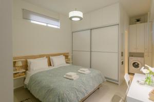 a bedroom with a bed with towels on it at Irma's Apartments in Pilos in Pylos