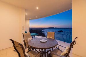 a room with a table and chairs on a balcony at Wake Up to the Pacific, Concierge Included in Playa Flamingo