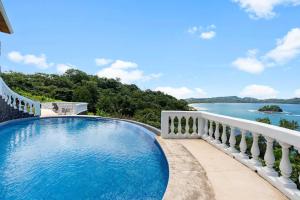 a swimming pool with a view of the water at Wake Up to the Pacific, Concierge Included in Playa Flamingo