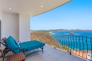 a balcony with a bench and a view of the ocean at Wake Up to the Pacific, Concierge Included in Playa Flamingo +27 photos
