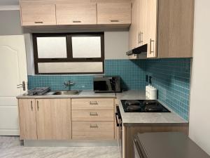 a kitchen with a sink and a stove top oven at J&A Corner - Swakopmund in Swakopmund