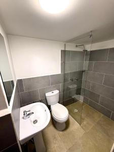 a bathroom with a toilet and a sink and a shower at Hotel Sol y Luna 2 in Medellín