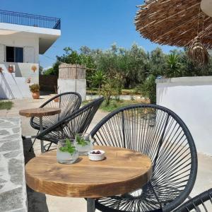 a wooden table and chairs on a patio at Sunsets and Olive Trees in Messini