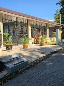 a building with a bench in front of it at Kassa Wista Azzul Rentals-with pool in Hormigueros