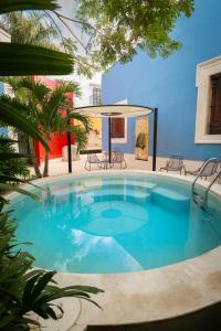 a large pool with blue water in a yard at Las Lupitas Hotel Boutique in Campeche