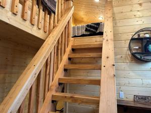 a staircase in a log cabin with wooden walls at Catch'em AK - Trout Haven in Soldotna