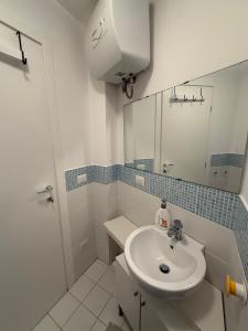 a white bathroom with a sink and a mirror at Bella Trinacria in Aragona +33 photos