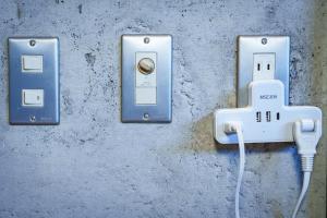 two electrical outlets with a cord plugged into them at Penthouse KOKO in Miyakonojō