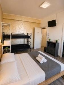 a bedroom with two bunk beds and a flat screen tv at Modena Station - Suite H24 in Modena