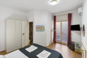 a bedroom with a bed with two white towels on it at Mirosa Luxury Rooms in Pompei
