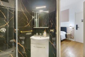 a bathroom with a sink and a shower at Mirosa Luxury Rooms in Pompei
