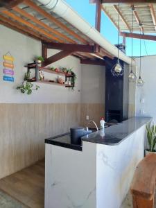 a kitchen with a sink and a counter top at Casa de veraneio - FA Beach in Conde
