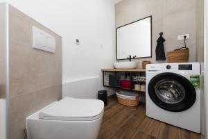 a laundry room with a washing machine and a mirror at Amare in Mali Lošinj +15 photos