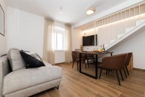 a living room with a couch and a table at Amare in Mali Lošinj
