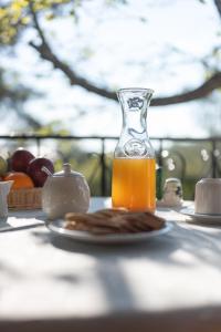 a bottle of orange juice next to a plate of food at Villa Marlene in Astris