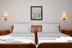 two beds sitting next to each other in a room at Villa Marlene in Astris