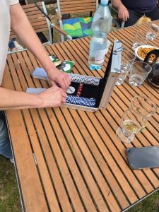 a picnic table with a bottle of water on it at Forest Sulimówka - dom na wyłączność z dala od sąsiadów in Ruda Kameralna