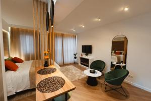 a bedroom with a bed and a table and chairs at Gate67 in Otopeni