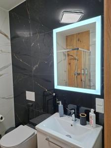 a bathroom with a white sink and a mirror at Apartament 3 - OpolskieNoclegi in Krapkowice +12 photos