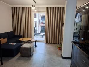a living room with a couch and a table at Apartament 3 - OpolskieNoclegi in Krapkowice