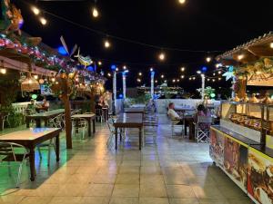 a restaurant with tables and people sitting at tables at Curacao Suites Hotel in Willemstad