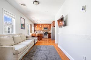 a living room with a couch and a kitchen at Spacious 2BR-1BA-4 Beds NYC MetLife Parking in Bayonne