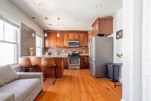 a kitchen with wooden cabinets and a stainless steel refrigerator at Spacious 2BR-1BA-4 Beds NYC MetLife Parking in Bayonne +26 photos
