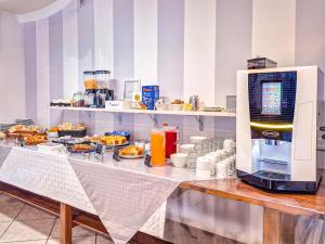 a buffet with food on a table in a restaurant at Hotel Luca in Valverde