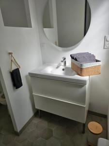 a bathroom with a sink and a mirror at L'Écrin Manceau Élégance, Sérénité & Confort in Le Mans